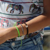 Black Raymi Bright Green bracelets that fight poverty on wrist