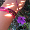 White Chasqui Wine Purple bracelets that help children on wrist