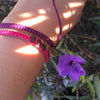 Black Chasqui Strawberry Pink bracelets that help children on wrist