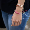 White Andes Strawberry Pink macrame artisan bracelets on wrist