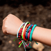 Black Cuzco Candy Pink bolivian bracelets on wrist