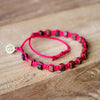 Black Andes Strawberry Pink macrame artisan bracelets on wood