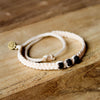 Black Chasqui Urban Khaki bracelets that help children on wood