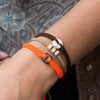 Black Raymi Crayola Orange bracelets that fight poverty on wrist