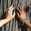 Black Raymi Crayola Orange bracelets that fight poverty on wrist