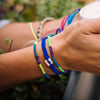 White Raymi Electric Blue bracelets that fight poverty on wrist