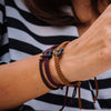 Black Tinkus Sweet Caramel donation bracelets on wrist