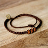 Brown Chasqui Chocolate Brown bracelets that help children on wood