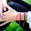 Brown Chasqui Carbon Black bracelets that help children on wrist