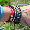 White Chasqui Candy Pink bracelets that help children on wrist
