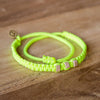 White Chasqui Electric Yellow bracelets that help children on wood