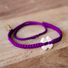 White Tinkus Violet Purple donation bracelets on wood